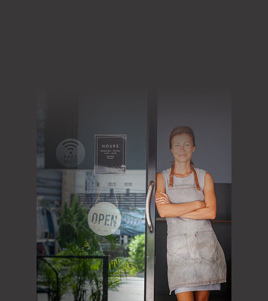 Shop owner standing outside of her shop