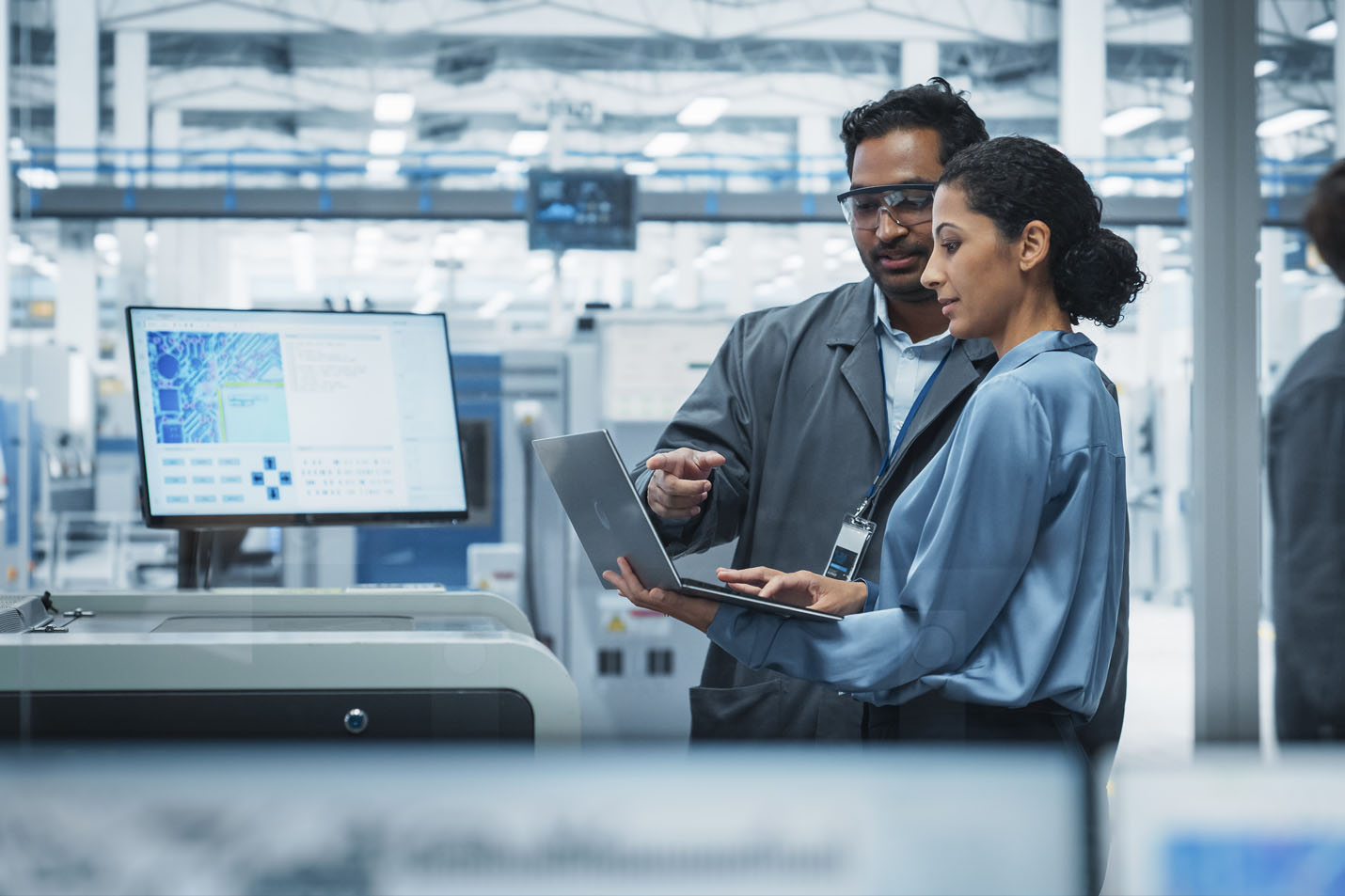 Two people working on a laptop